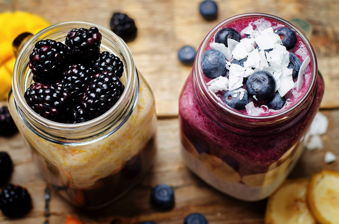 A blueberry and banana smoothie with yoghurt, and a banana and mango smoothie with chocolate and blackberries