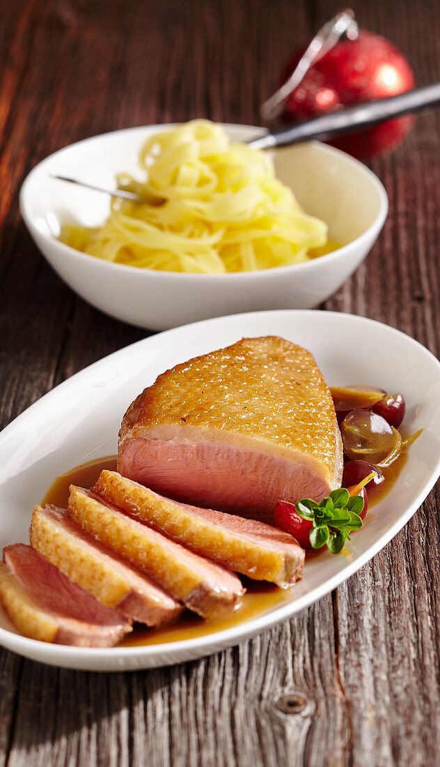 Roasted duck breast with a grape sauce and tagliatelle