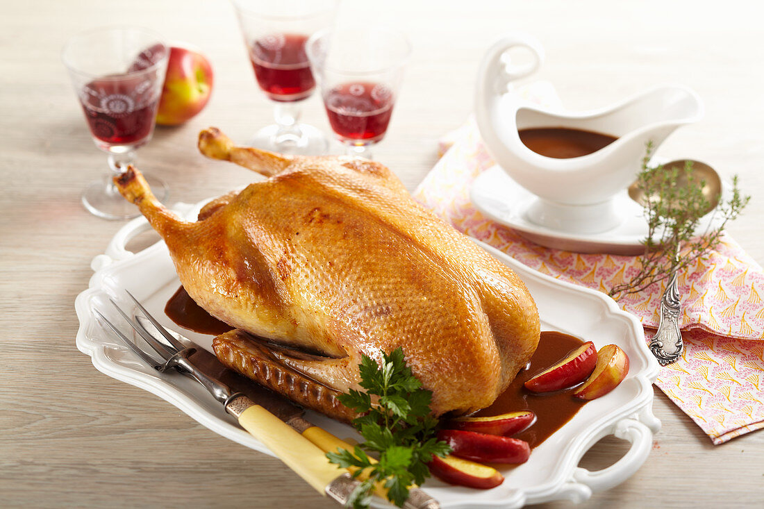 Roasted goose for Christmas dinner filled with apple stuffed and served with apple wedges