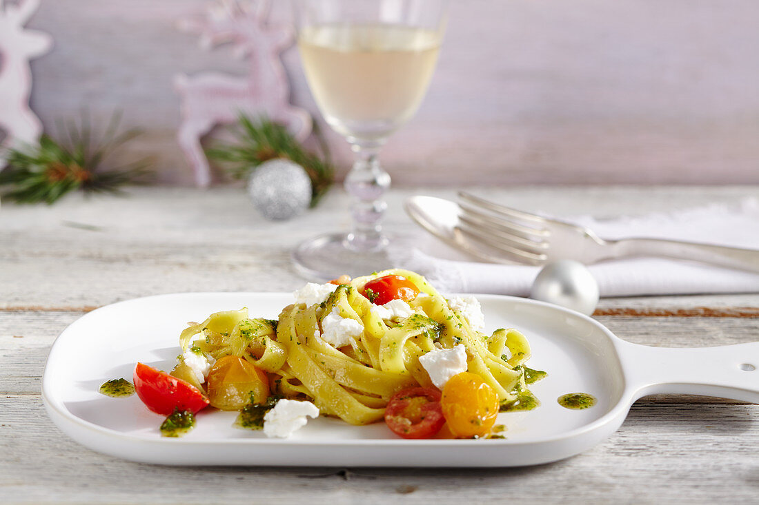 Tagliatelle with braised cherry tomatoes, walnut and parsley pesto and goat's cream cheese