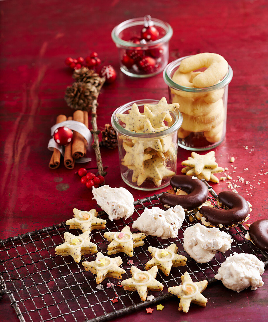 Various Christmas biscuits on a wire rack and in jars