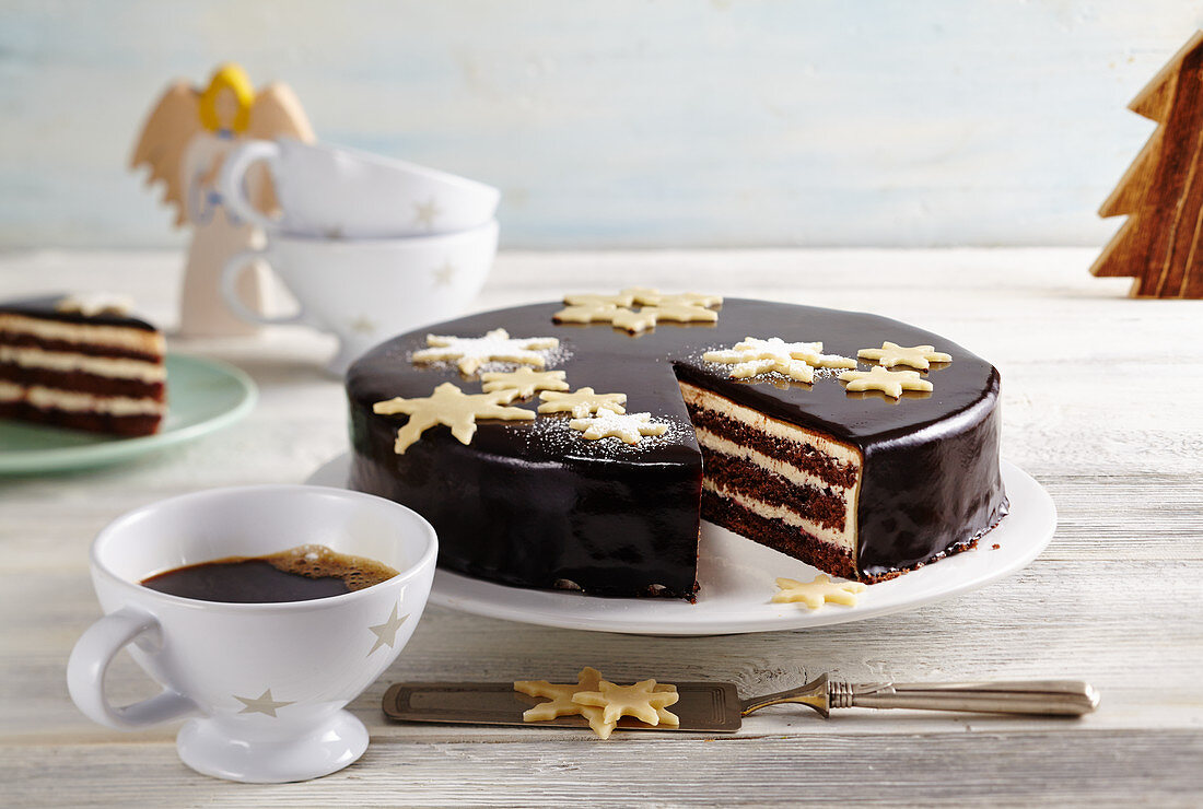 A Christmas star cake with butter cake, stollen liqueur, fruits of the forest jam, marzipan and cocoa glaze