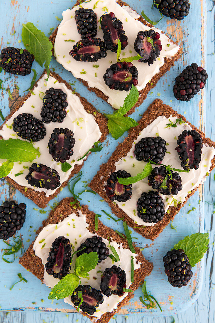 Vegan cream cheese with blackberries on a rye crisp bread