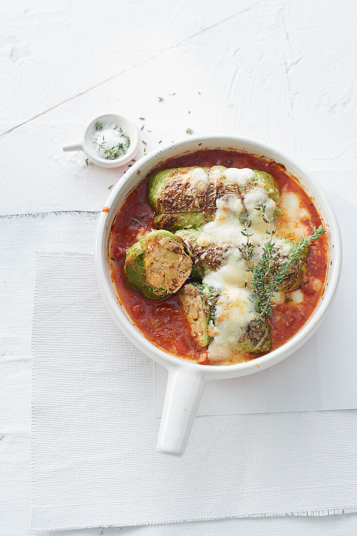 Braised savoy cabbage rolls with tomato and cheese sauce