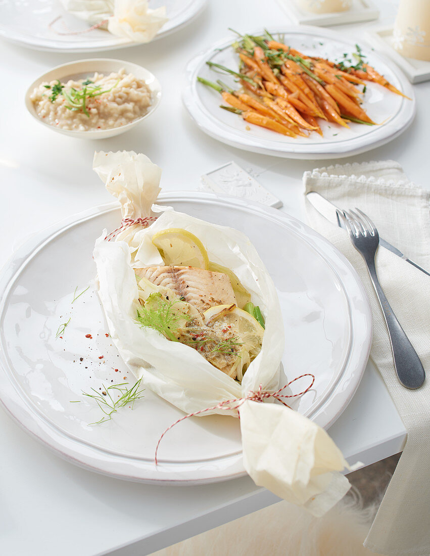 A fish parcel with fennel, lemon butter, carrots and risotto for Christmas