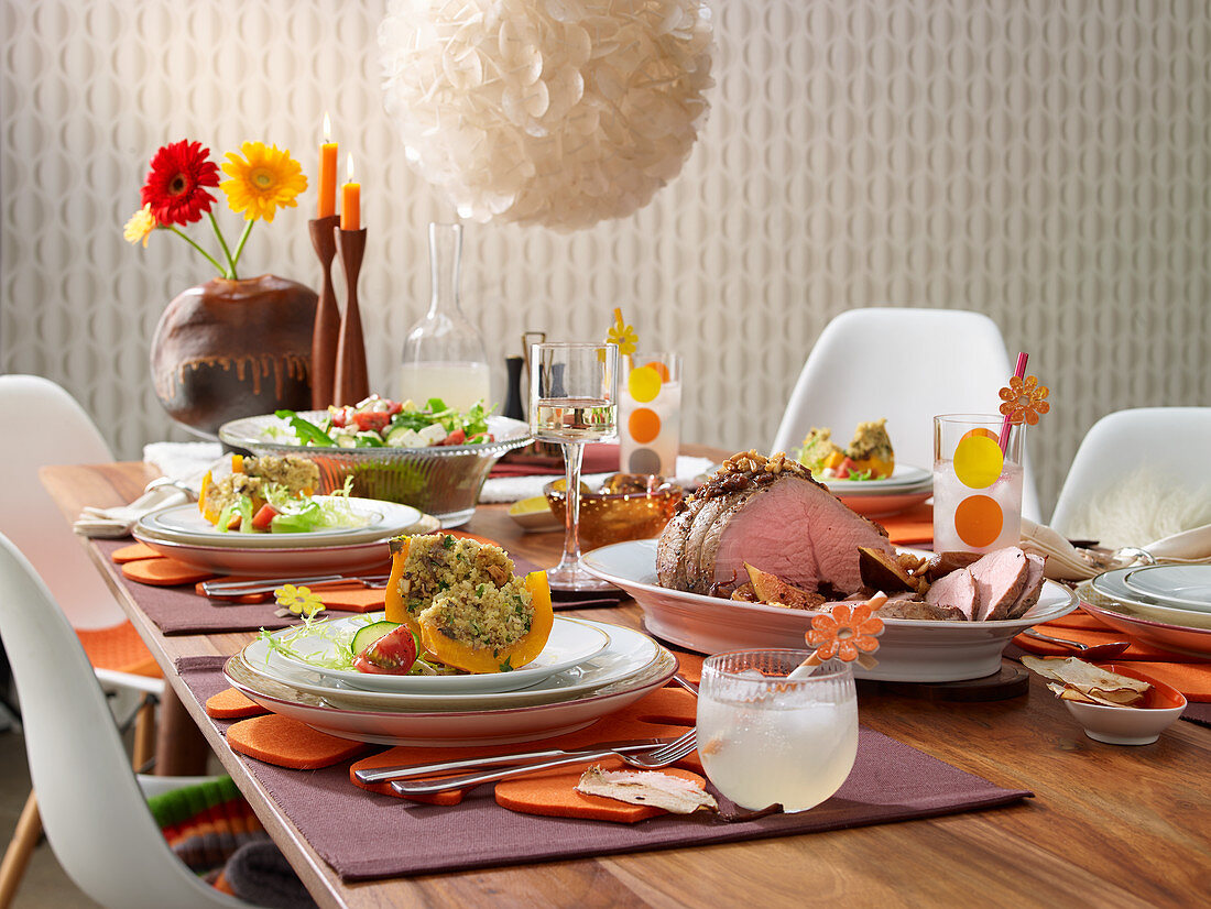 Baked pumpkin filled with quinoa, honey roast meat with fig sauce, salad, and pear lemonade