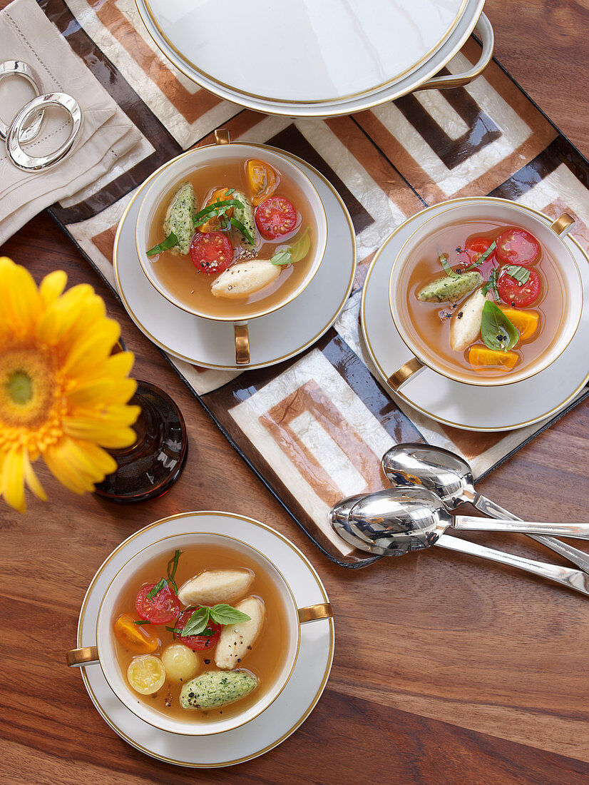 Clear tomato soup with cheese dumplings