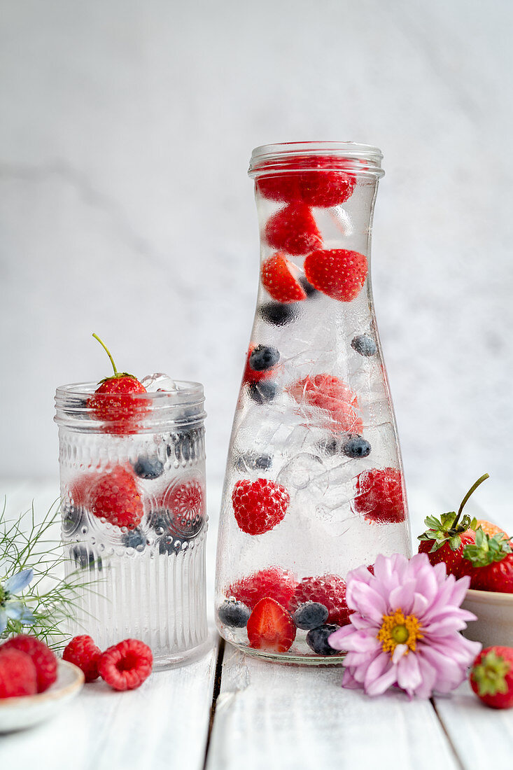 Water with fresh berries and ice cubes