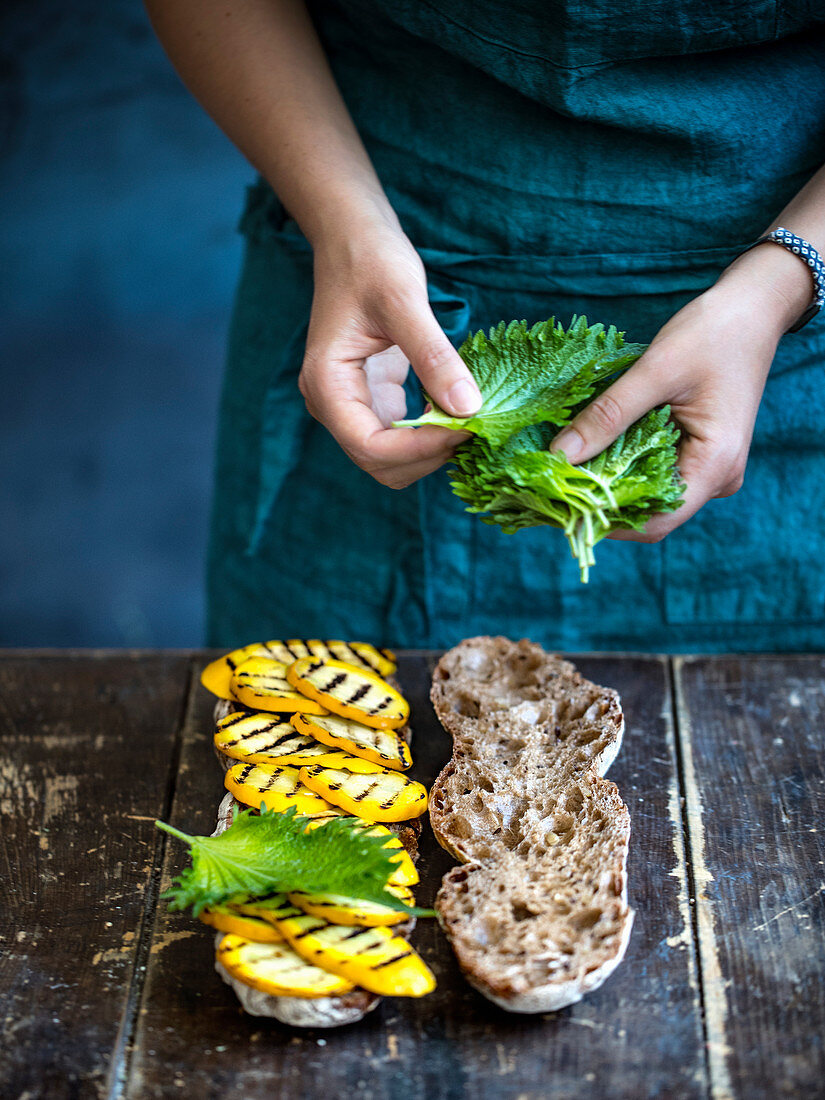 Ciabattabrot mit gegrillten gelben Zucchini und Shisoblättern belegen
