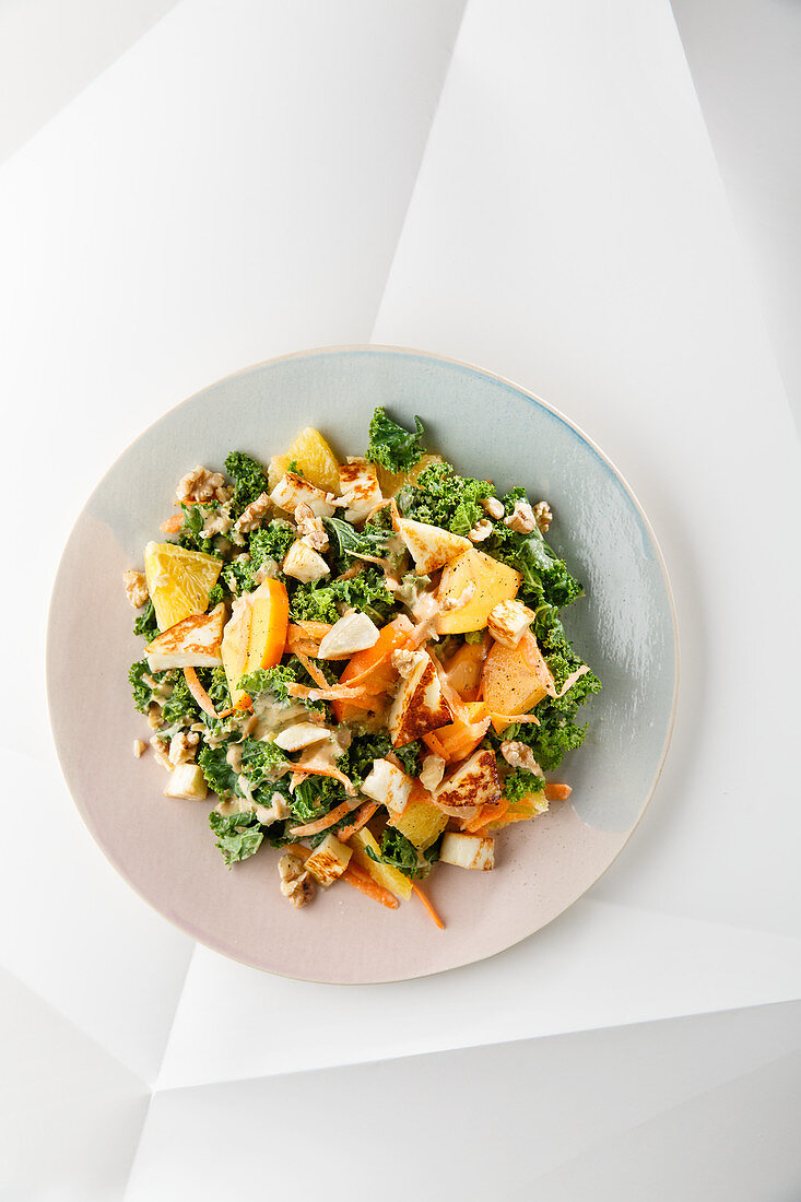 Autumnal kale salad with persimmon and halloumi