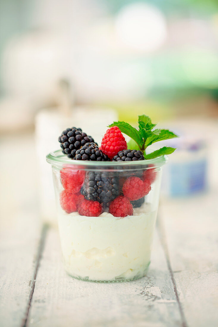 Cottage cheese with fresh berries and mint in a glass (low carb)
