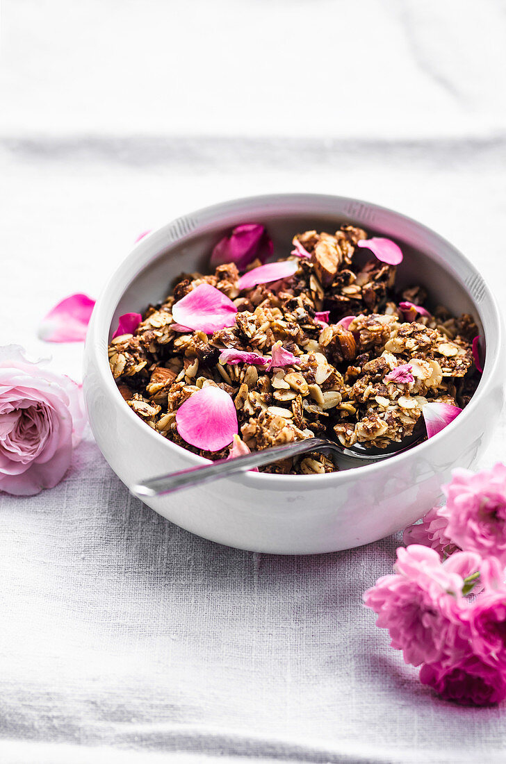 Almond and rose granola in handmade bowl on linen