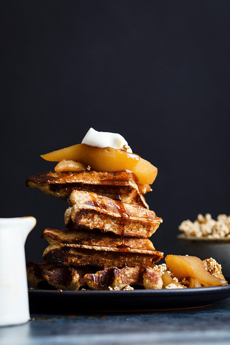 Waffles on plate with pears and whipped cream