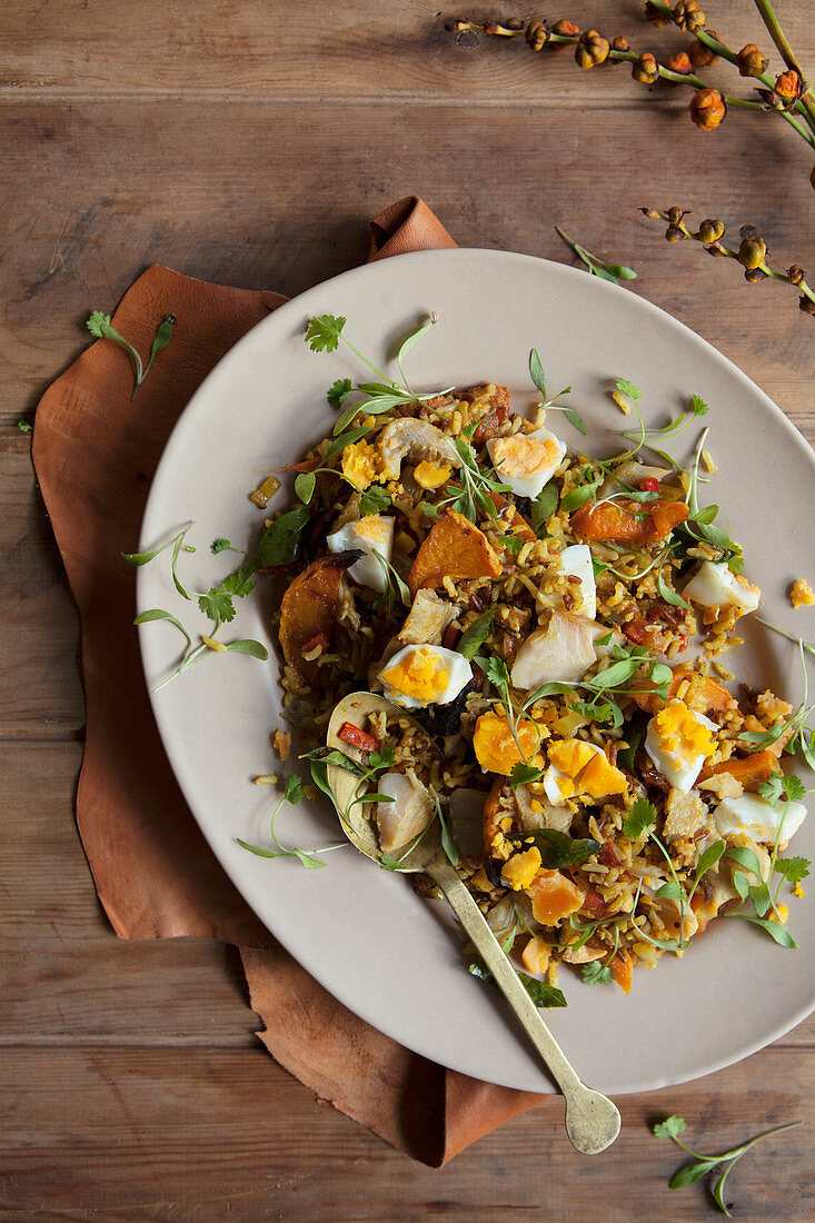 Kedgeree on oval plate with wooden background