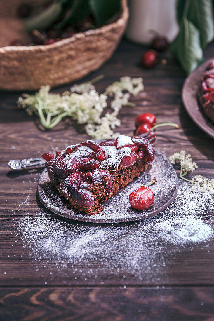 Slice old cherry chocolate cake on a dessert plate