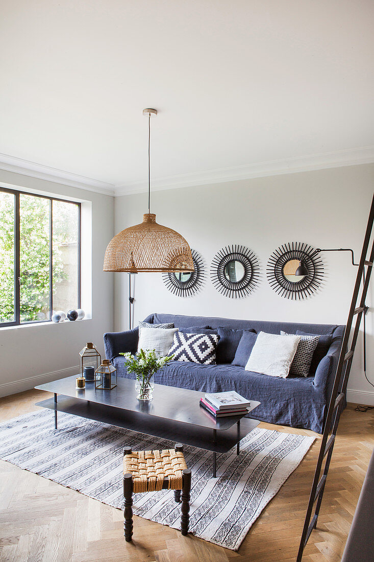 Metal coffee table and sofa with grey cover in living room