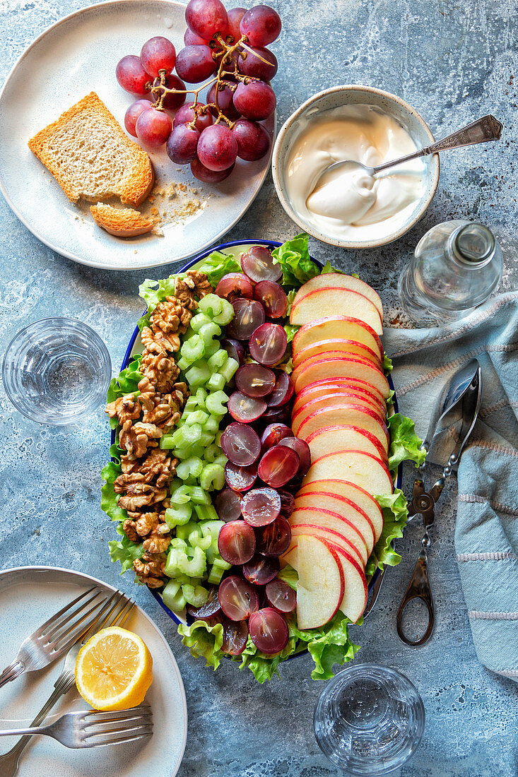 Deconstructed Waldorf salad with celery, apple, grapes and walnuts on a plate