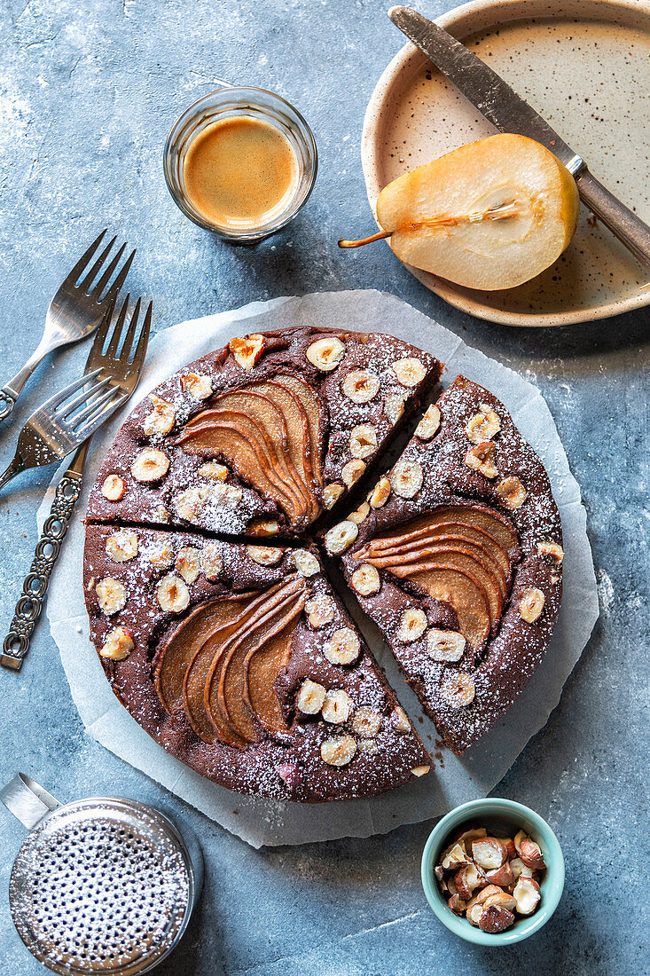 Chocolate cake with pears and hazelnuts on the table