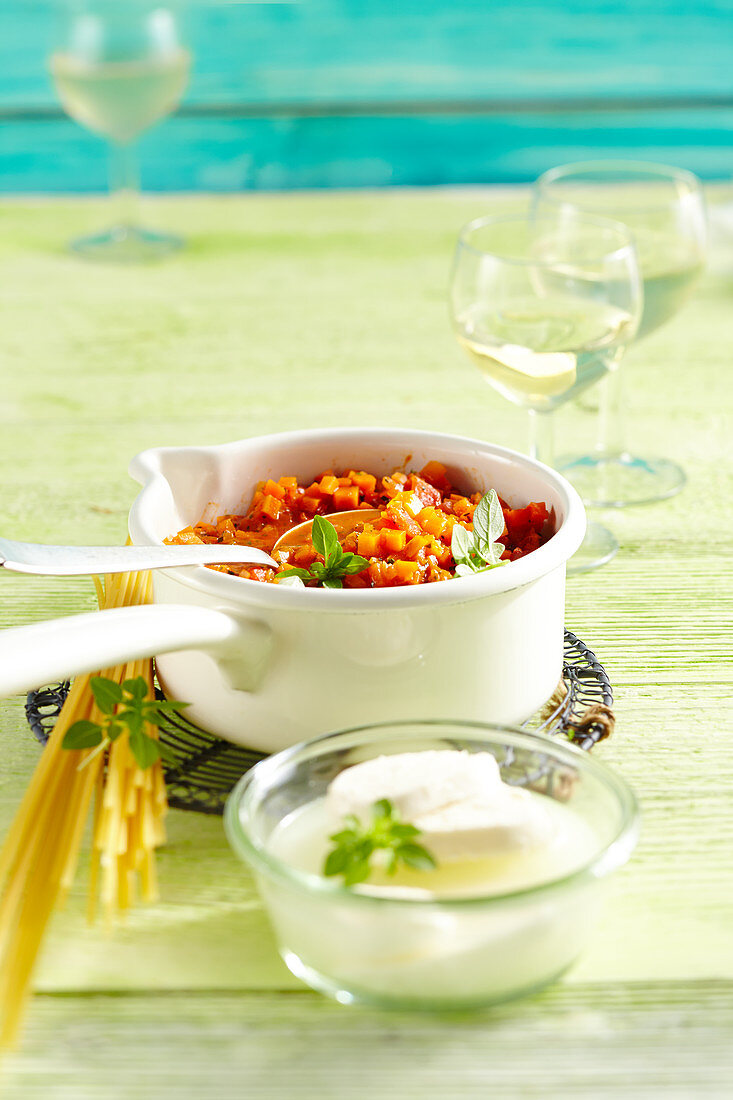 Vegetarian carrot and tomato bolognese in a small enamel pot