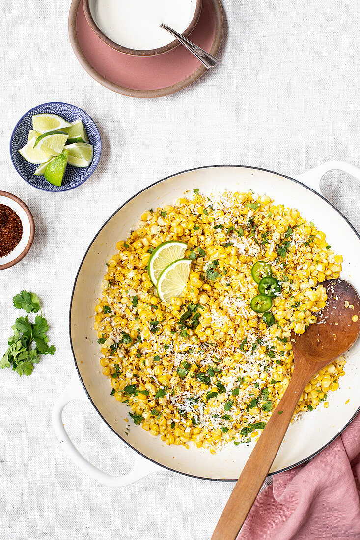 Mexican corn with herbs and chili in a pan (top view)