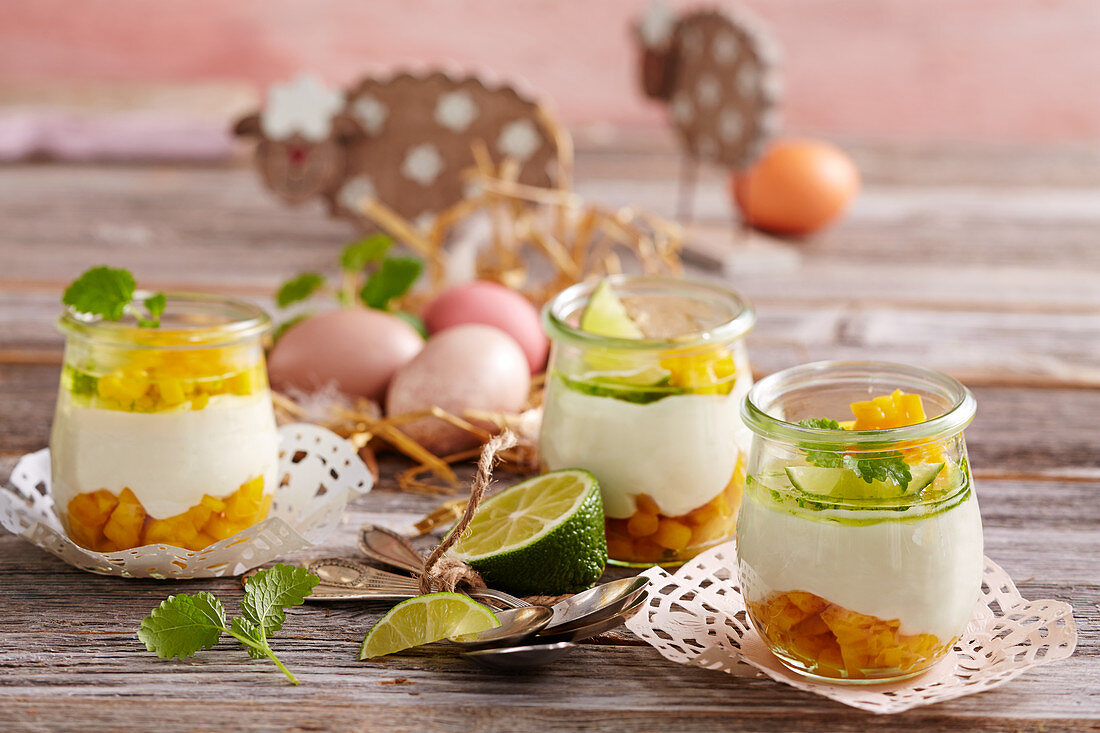 Yogurt cream with lime and mango in glasses for Easter