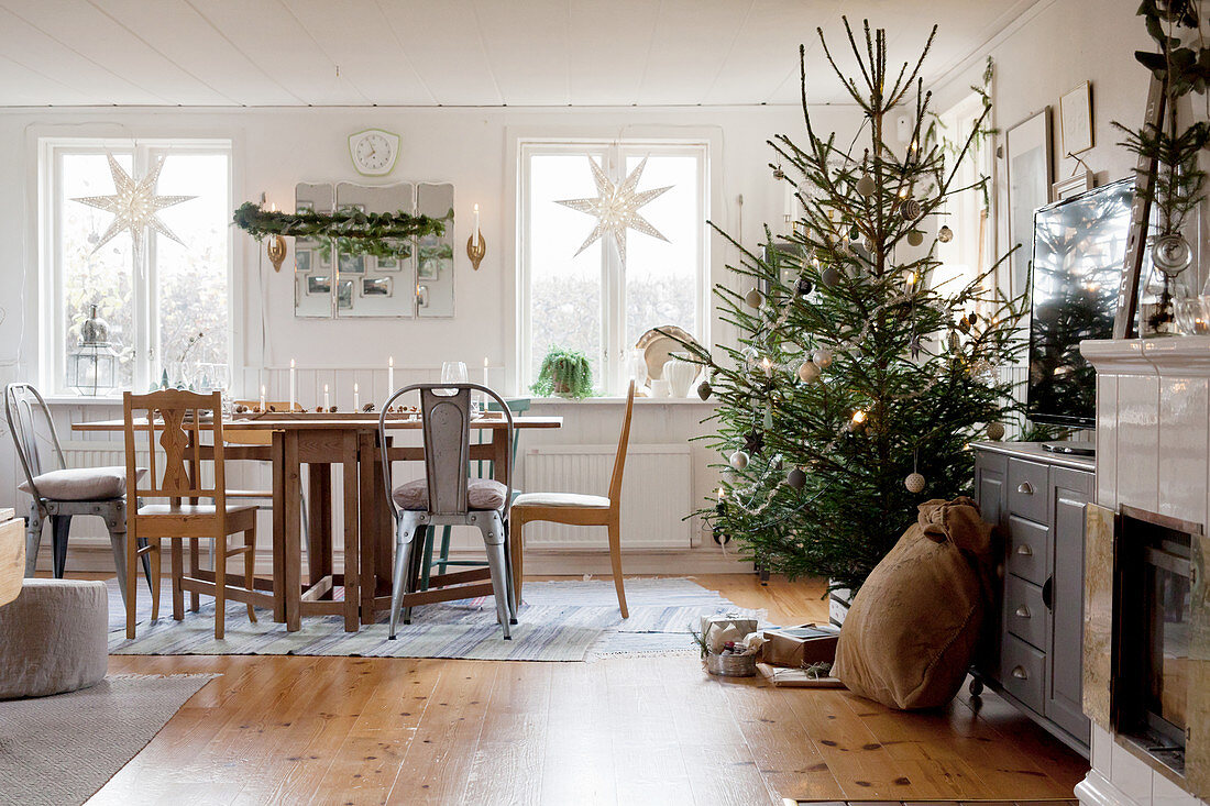 Christmas decorations and decorated tree in rustic living room