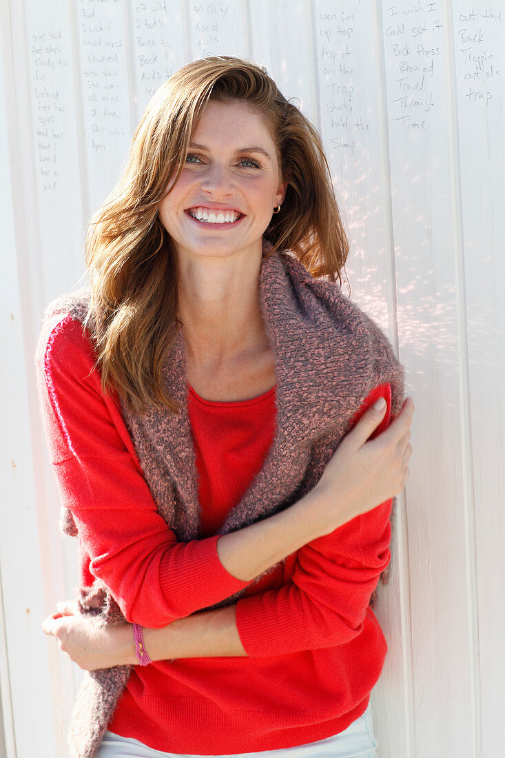 A young woman wearing a red jumper