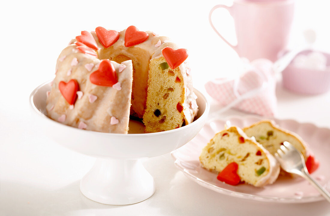 Small lime cakes with candied fruit, icing and red hearts for Mother's Day