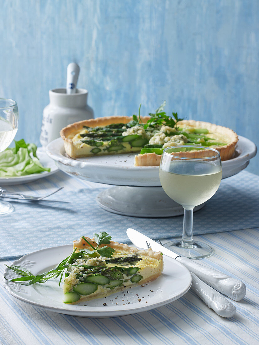 A slice of asparagus quiche on a plate