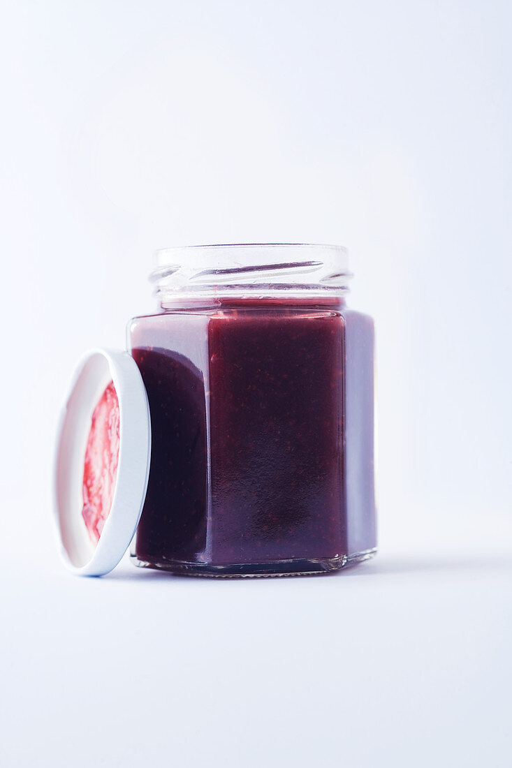 A jar of fig jam against a white background