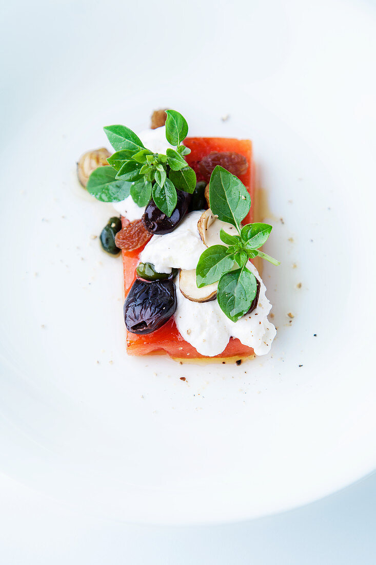 Roasted watermelon with goat's cheese and hazelnuts