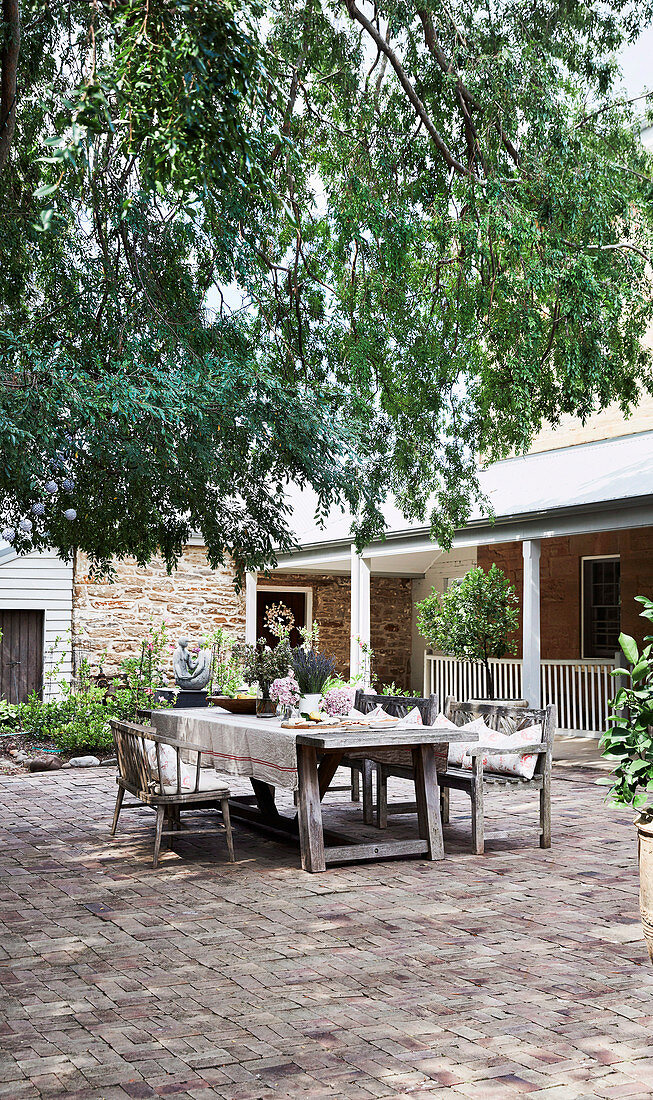 Rustic garden table in the summer courtyard