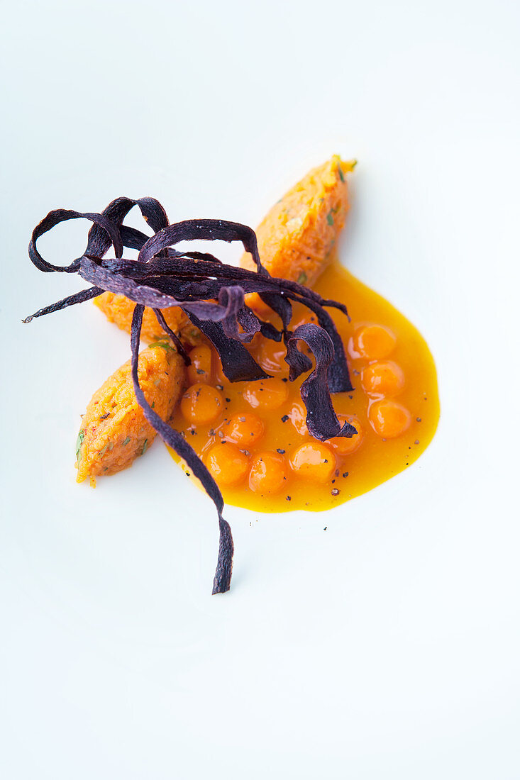 Carrot soup with carrot balls and fried carrots