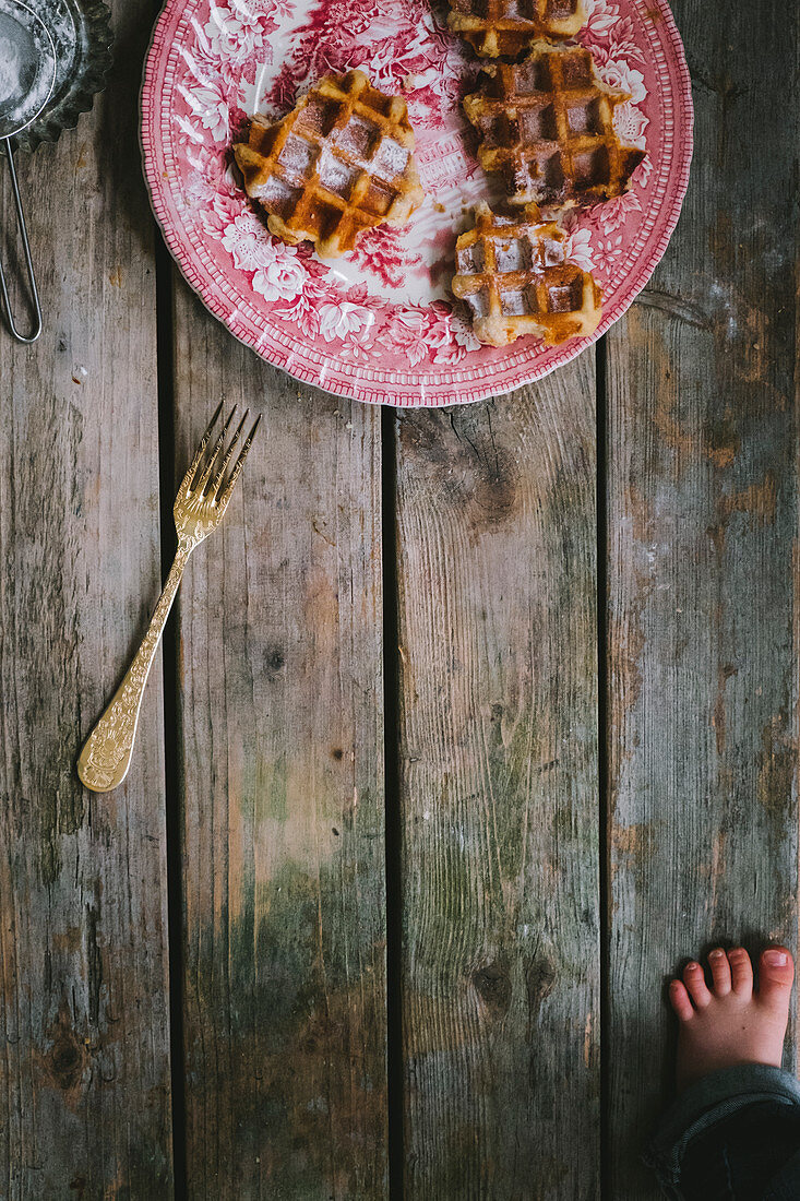 A brocante French plate with waffles and powdered sugar