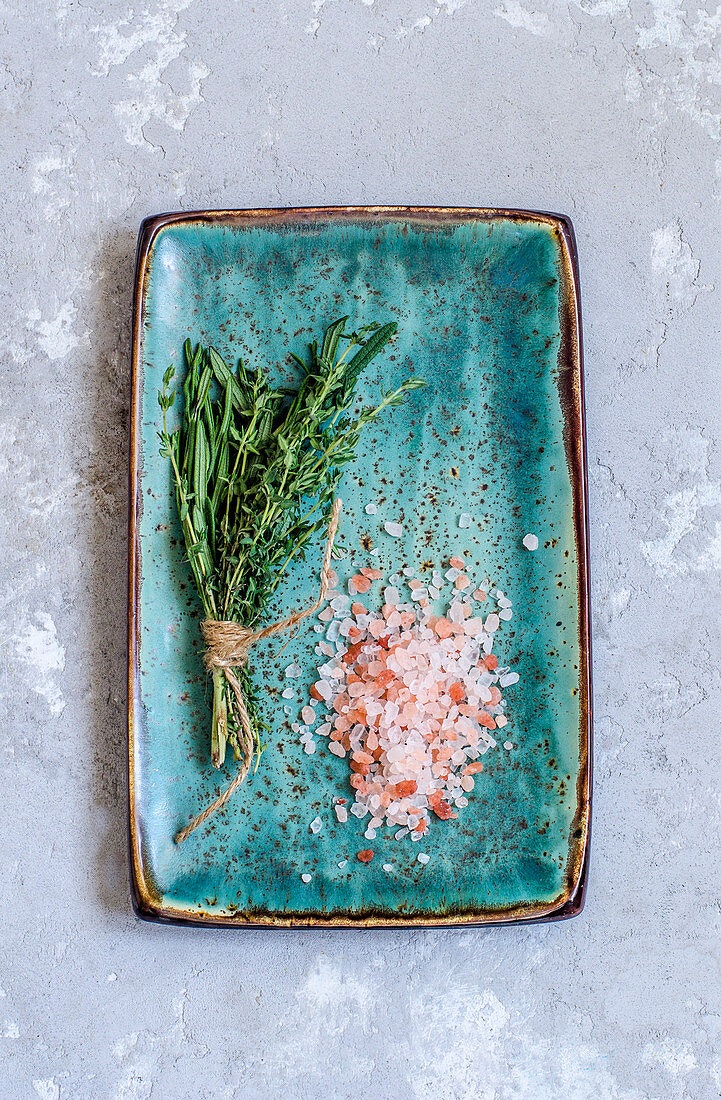 Himalayan salt and Provencal herbs on a turquoise-colored kraft plate
