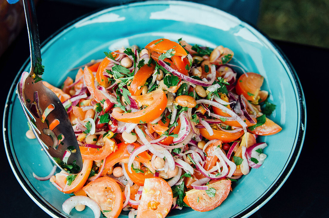 Tomato salad in bowl with spoon