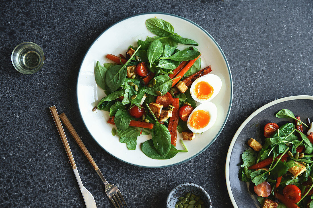 Blattsalat mit gebratenem Käse, Karotten, Kirschtomaten und Kürbiskernen