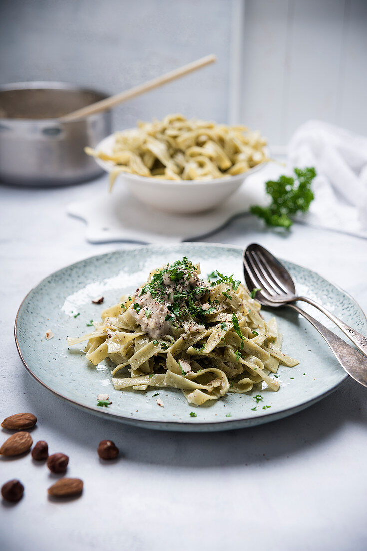 Vegan spinach tagliatelle with a hazelnut and almond sauce
