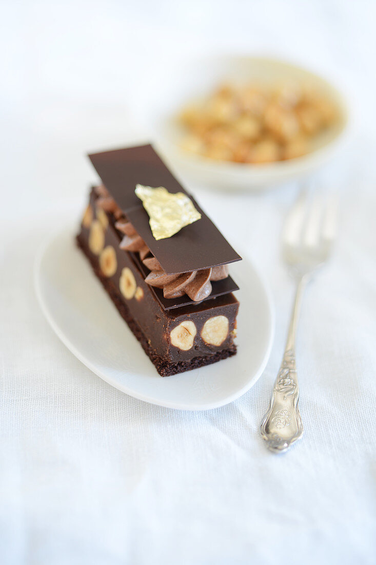 Chocolate-nut slices with chocolate mousse and gold leaf