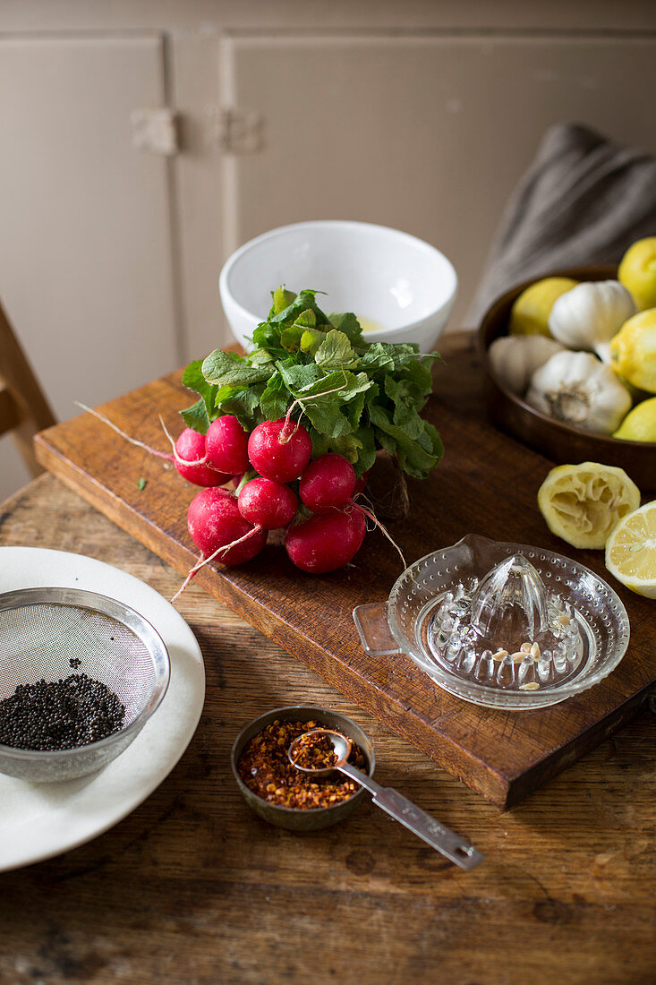 Radishes, lemons, garlic and spices in a kitchen