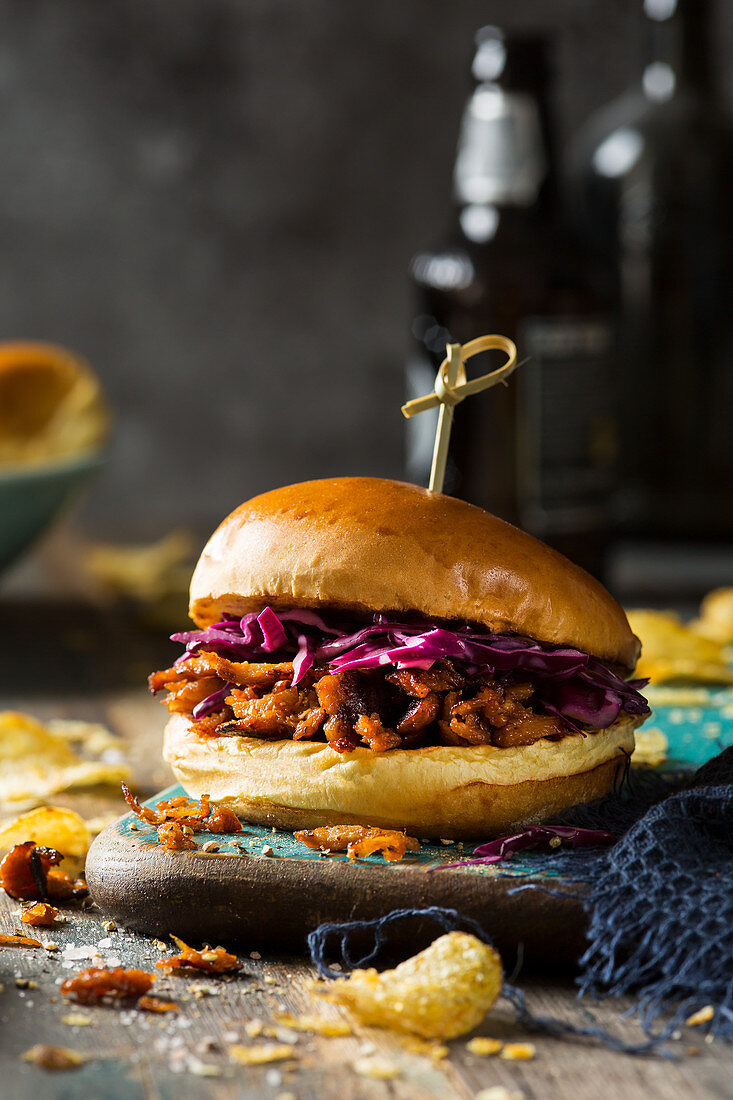 Meat free Vegan pulled pork made form soya and jack fruit in a barbeque sauce served on a brioche bun with pink winterslaw
