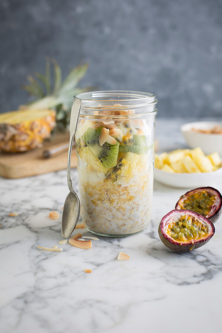 Over night oats with pineapple, kiwi, coconut and passion fruit