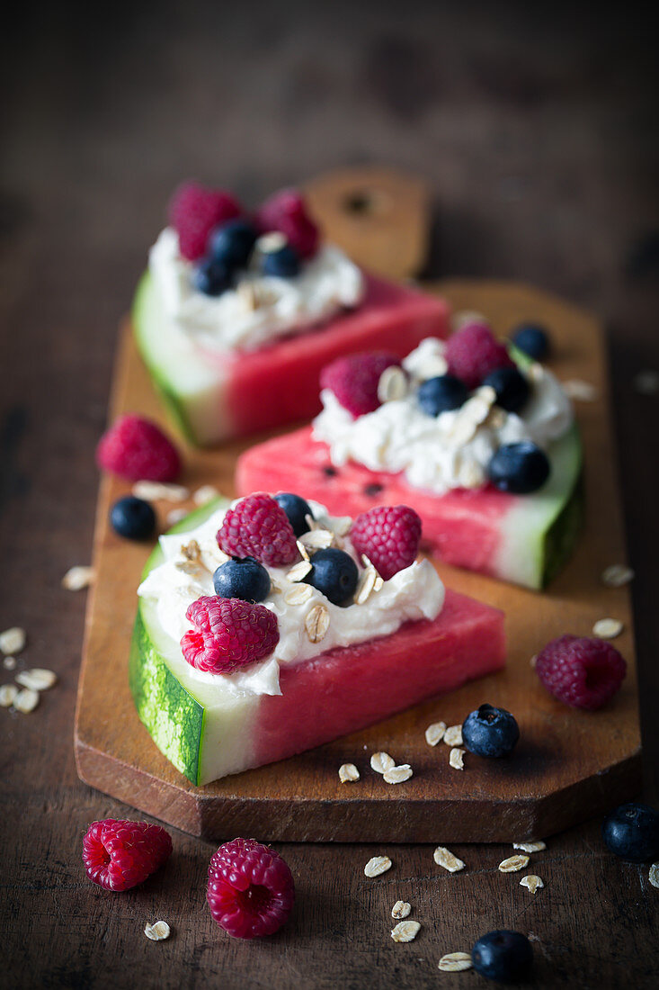 Watermelon slices with whipped cream and berries