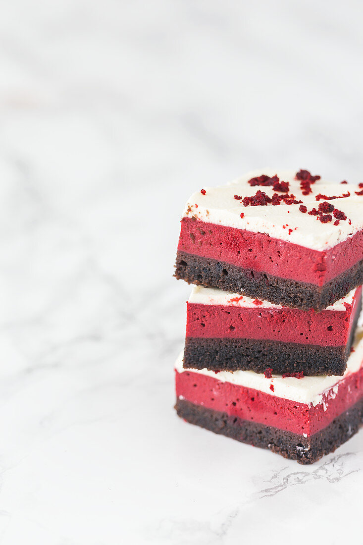 Stack of a red velvet cheesecake brownie squares