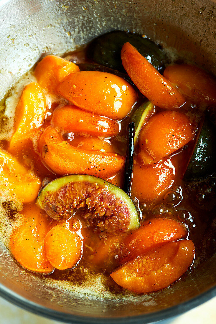 Stewed apricots and figs in a pot (seen from above)