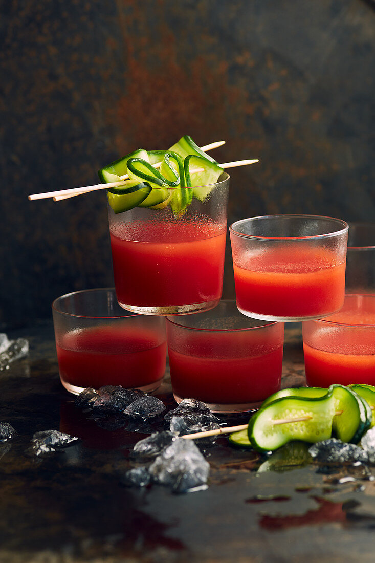 Gazpacho served in glasses with cucumber skewers