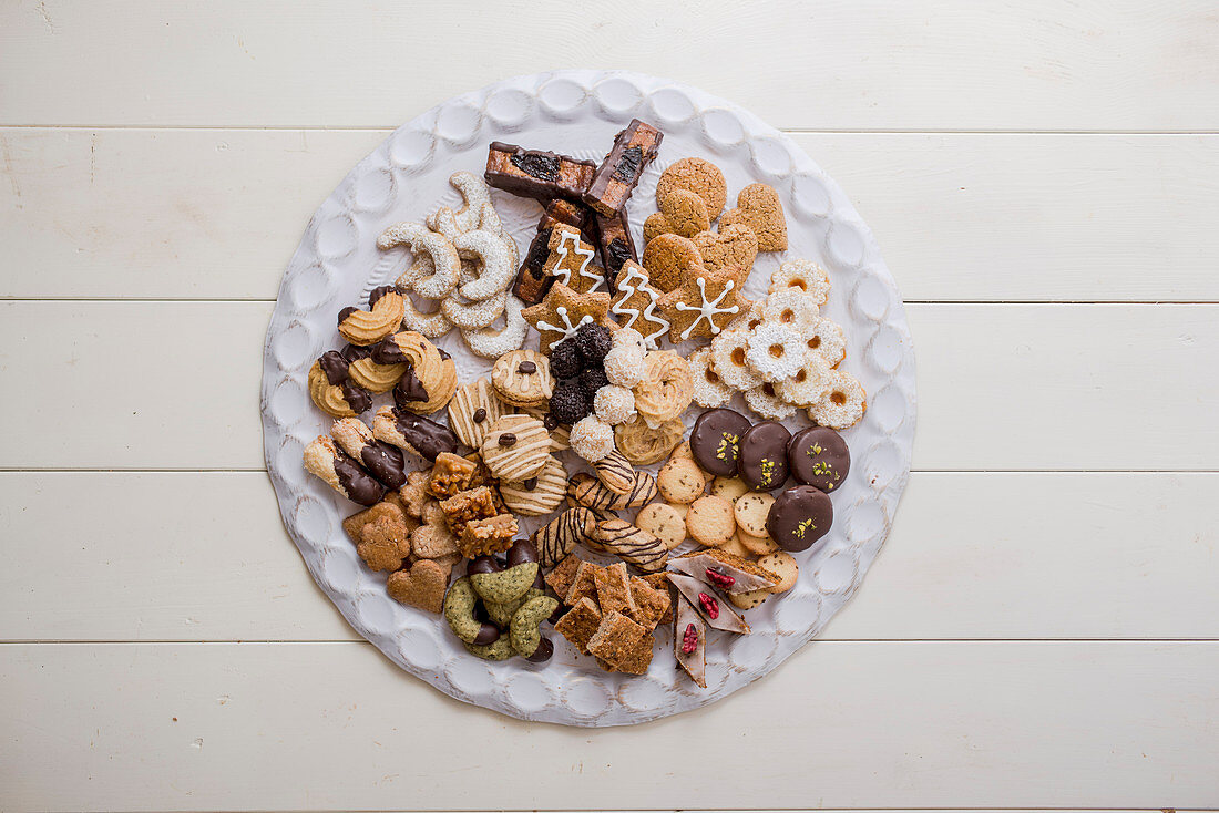 Various Christmas cookies on a biscuit platter (top view)