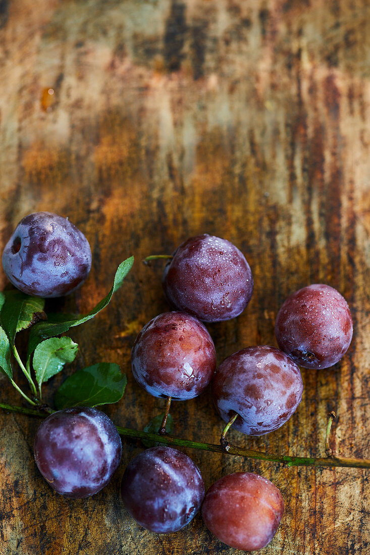 Fresh plums on a wooden surface