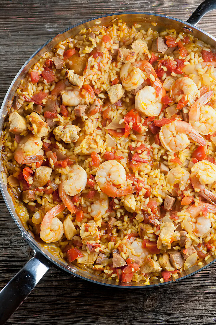 Paella with shrimps in a pan (top view)