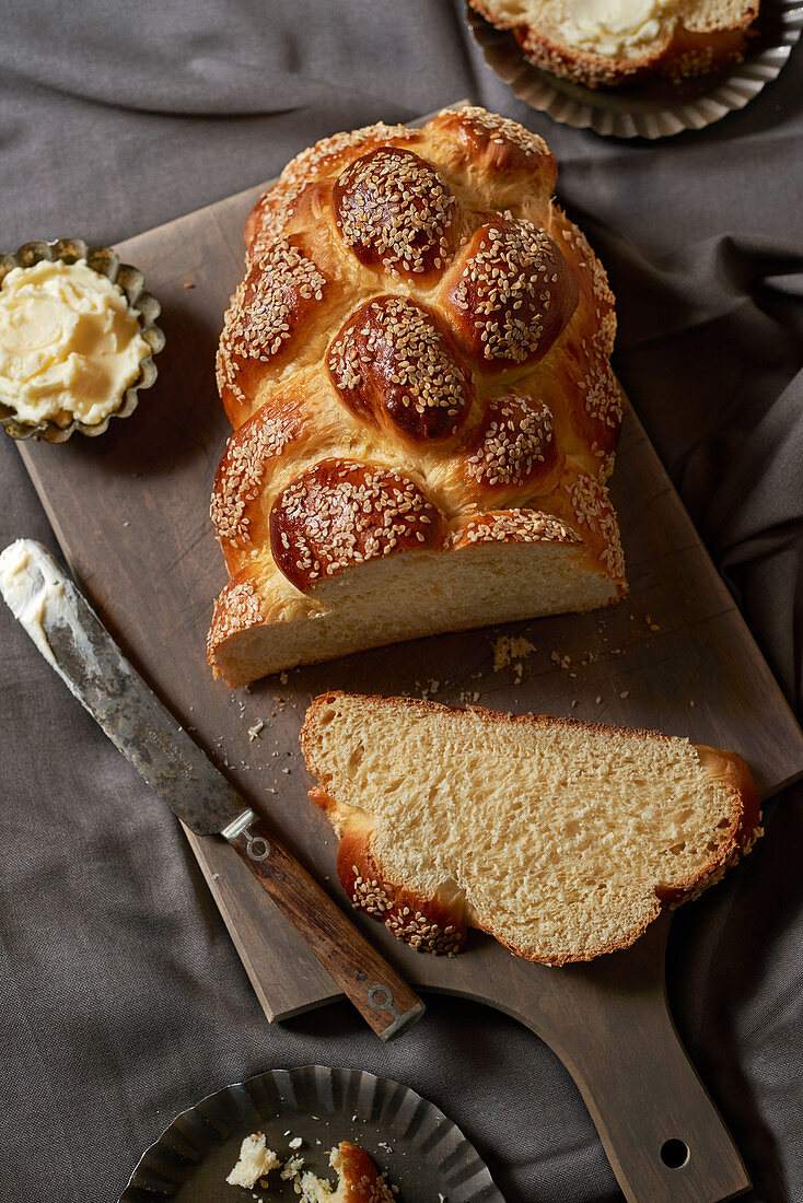 Challah (Jewish bread plait) sliced on a wooden board